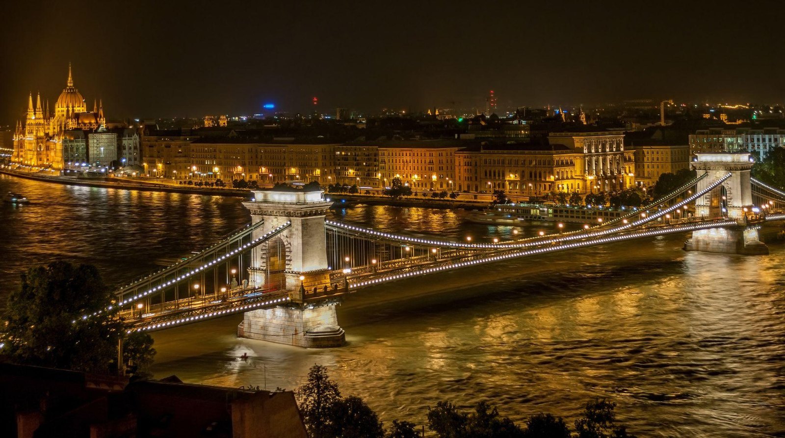 Budapest bei Abendlicht mit beleuchteter Brücke über die Donau
